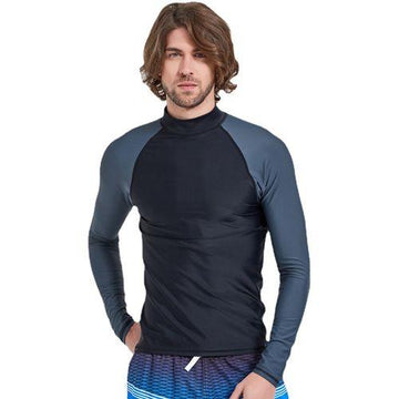Man wearing black and gray long-sleeve rash guard with blue patterned swim trunks on white background