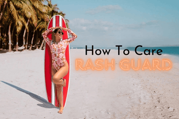 Woman in floral rash guard standing on sandy beach with red striped surfboard and palm trees