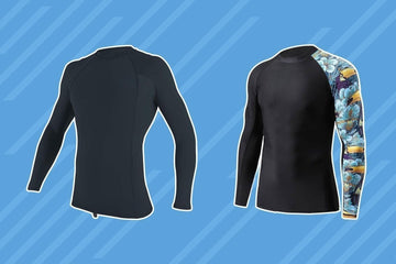 Two long-sleeve rash guards on blue background, one solid black and one black with floral and toucan print sleeve